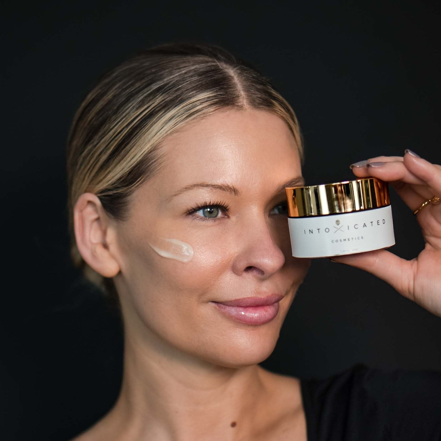 Model holding Antidote Moisturizer by Intoxicated Cosmetics - anti-aging hydration